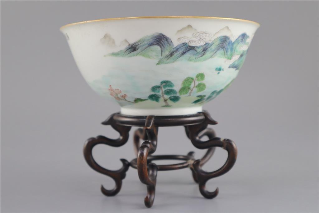 A Chinese enamelled landscape porcelain bowl, Jiaqing mark and of the period (1796-1820), 15.5cm diameter, wood stand